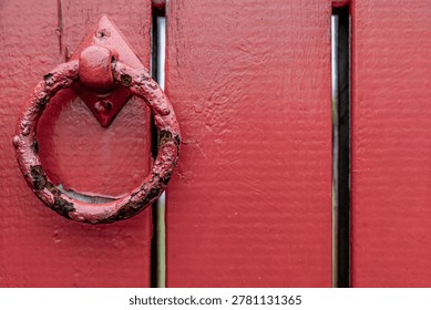 Rusty Ring Handle on a Red Wooden Door