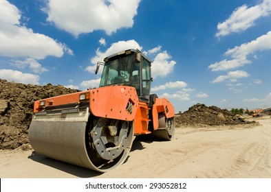 Rusty roll compactor working on sand area at construction site - Powered by Shutterstock