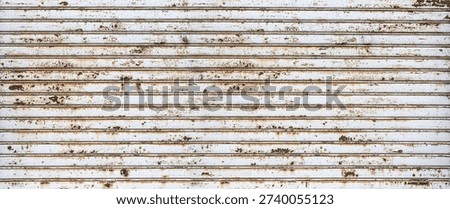 Rusty rolling metal shutter creating an old textured background