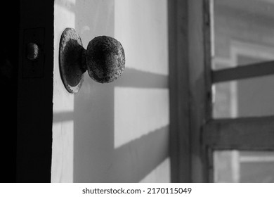 Rusty Round Doorknob On Old Door