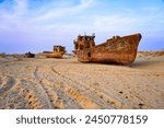 Rusty shipwreck lying on the seabed of the dried-up Aral Sea in Moynaq (or Muynak), a former fishing town in Karakalpakstan, Uzbekistan