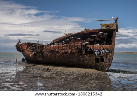 
rusty shipwreck on the Motueka beach, New Zealand