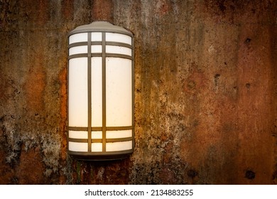 Rusty Stained And Marked Stone Wall With A Mission Style Lamp