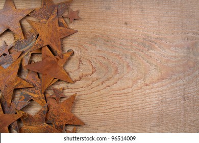 Rusty stars on a wooden background, room for copy space