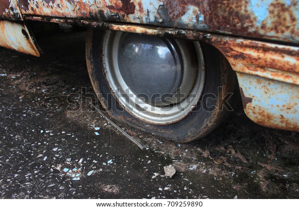Rusty steel,Flat tire,old car flat tire in the\
park,Car rust