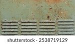 Rusty surface of louvre air vent. Detailed grungy texture of rusted steel ventilation grill. Weathered old panel with rust, chipped and peeling, aged iron, corrosion details, flaking fade green paint