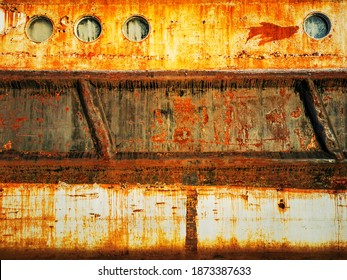 Rusty Surface Of The Old Ship Hull With Round Portholes