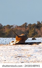 Rusty tank in the snow on the military training area


