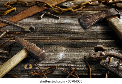 Rusty tools on old dark plank background with copy space
