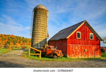 A rusty truck at the old barn. Old truck and old barn. Truck and barn  in old farm. Red barn and rusty truck