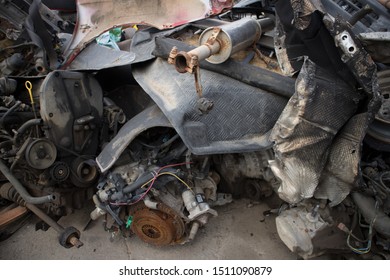 Rusty Vehicle Engines, Exhausts, Aluminum Tread Plate And Other Parts, Stacked In An Unarranged Order. Awaiting Dismantling, Recycling Or Re-sale. At A Car Cemetery. Kozani, Greece.