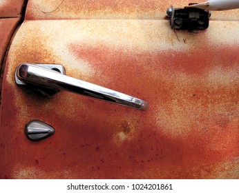 Rusty Vintage Truck Door With Shiny Silver Handle.