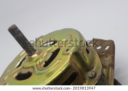 rusty washing machine dynamo on a white background