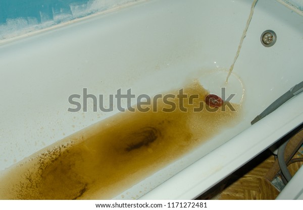 rusty water runs out of the\
tap