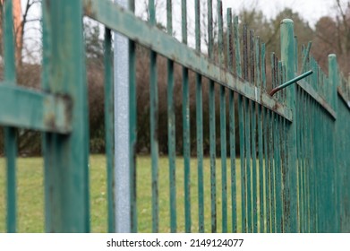 Rusty And Weathered Green Painted Metal Fence