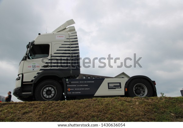Ruswil - Switzerland / June 21, 2019. Wave Rally of\
electric vehicles. An electric truck from the Futuricum company in\
Winterthur (Switzerland) shows the technical parameters painted on\
its side.