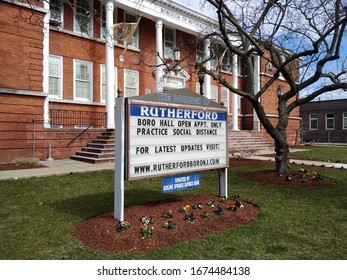 Rutherford, New Jersey / USA - March 16 2020: Sign On The Front Lawn Of Boro Hall Advising Residents That The Borough Of Rutherford Is Practicing Social Distancing; Open By Appointment Only.