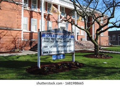 Rutherford, New Jersey / USA - March 24 2020: Sign On The Front Lawn Of Boro Hall Advising Residents That The Borough Of Rutherford Is Practicing Social Distancing; Open By Appointment Only.