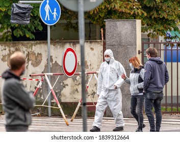 RUZOMBEROK, SLOVAKIA - OCTOBER 18, 2020: Medic In White Protective Suit And Mask Walking Away From Hospital