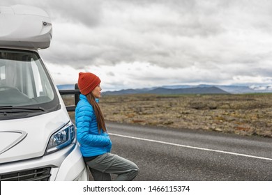 RV Camper Trailer Travel Woman Driving Motorhome Camping Van On Iceland Road Trip. Asian Tourist Driver Taking Break On Adventure Fall Autumn Vacation Looking At Nature Landscape.