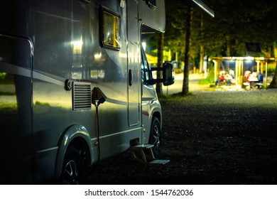 RV Camping At Night. Motorhome Campsite. Recreational Vehicle Class C. Summer Vacation.