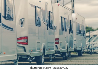 RV Dealership. Line Of Brand New White Trailers Parked In The Dealer's Car Park.