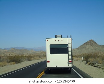     RV driving through desert, room for text.                           