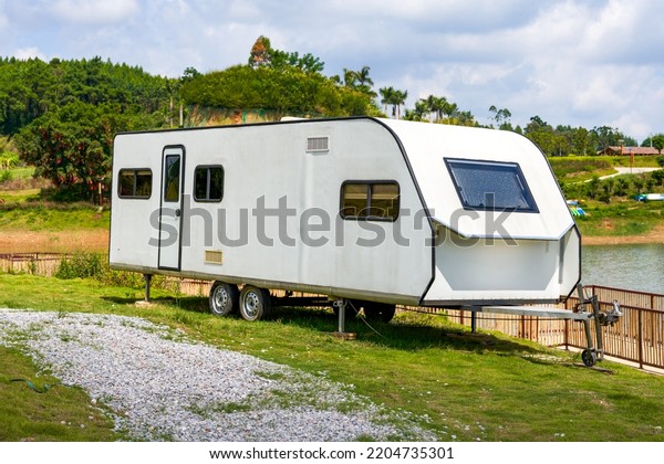 An RV parked on the lawn\
outdoors