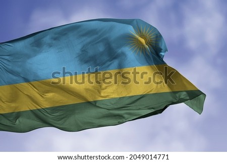 Rwanda flag isolated on the blue sky with clipping path. close up waving flag of Rwanda. flag symbols of Rwandan.