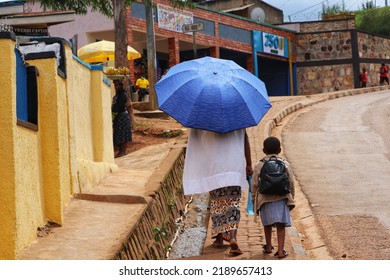 Rwanda - June, 2022: The People Of Rwanda. Mother Walking Her Kid Back From School In Kigali.