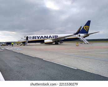 The Ryanair Plane Stands On The Tarmac At The Warsaw Modlin Airport. Airport Staff Checks The Plane. Stairs To The Door Of The Plane. October 2022, Warsaw Modlin, Poland