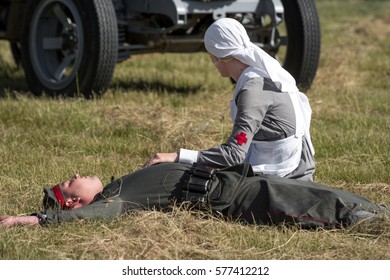 RYBNIK, POLAND - JUNE 18, 2016: Nurse Kneeling Over The Dead German Soldier Who Dies From Air Attack During WWI Historical Reconstruction