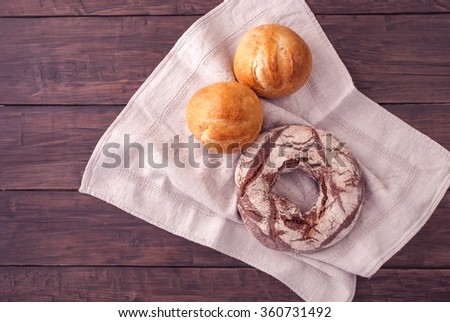 Rye bagel bread and bunson old rustic table. Top view.Toned