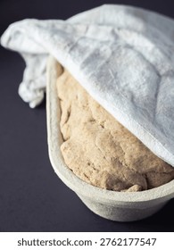 Rye bread dough fermenting in a fermentation basket or banetone, close up