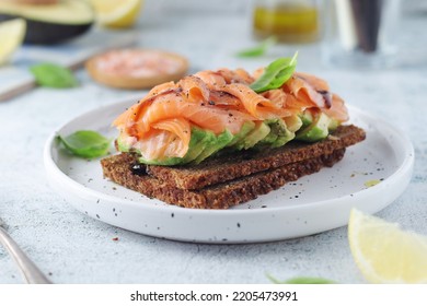 A Rye Bread Sandwich With Avocado And Salmon