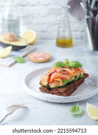 A Rye Bread Sandwich With Avocado And Salmon