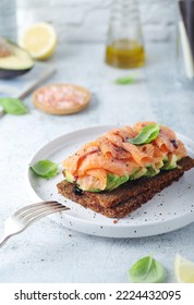 A Rye Bread Sandwich With Avocado And Salmon