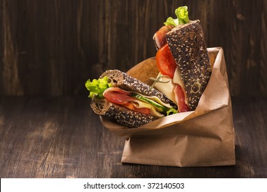 Rye bread sandwiches with ham, cheese and vegetables in a craft 