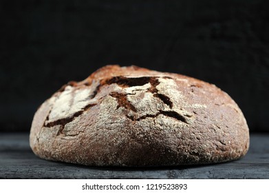 rye bread, whole loaf on dark rustic background