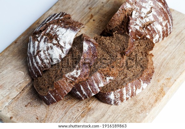 rye fresh loaf of bread, soft rye bread with a\
crisp crust, fresh and delicious rye bread made from rye flour ,\
divided into parts