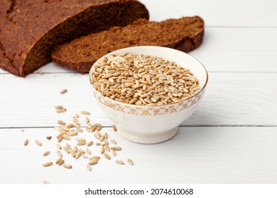 Rye seeds in a white plate on the background of rye bread
 - Shutterstock ID 2074610068