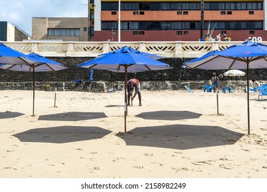 S, BRAZIL - Nov 02, 2021: Blue umbrellas at Farol da Barra beach in Salvador, Bahia, Brazil