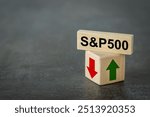 S and P 500 index symbol. Wooden blocks with an arrow that symbolizes that the S and P 500 index is changing trend, goes up or down. Business concept. Copy space.