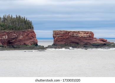 S sea stack formed in red sandstone by erosion. Located near St. Martins New Brunswick in the Bay of Fundy.