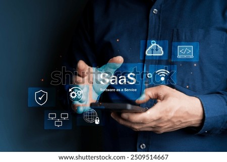 SaaS Concept, Software as a Service, A man types smartphone with digital icons representing various aspects of Software as a Service (SaaS), emphasizing modern technology platforms and cloud computing
