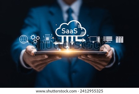 SaaS (software as a service) concept, Businessman show virtual screen of SaaS icons for software services on cloud system. Internet and networking technology.