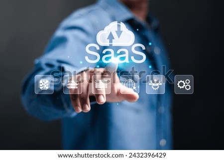 SaaS, software as a service concept. Businessman touching cloud SaaS icon on virtual screen. software services on cloud system. Internet and networking technology. 