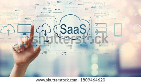 SaaS - software as a service concept with hand pressing a button on a technology screen