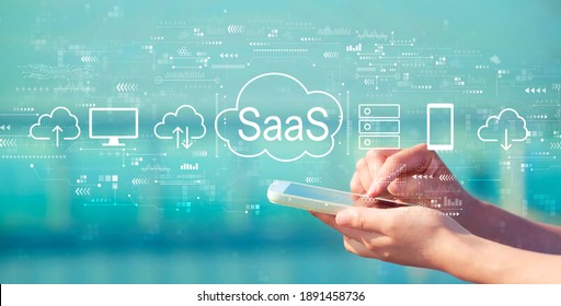 SaaS - software as a service concept with person holding a white smartphone