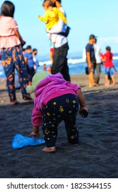 Saba Beach - Bali - Indonesia, October 1st 2020. An Under 5 Years Baby Is Collecting Plastic Garbage At The Saba Beach.